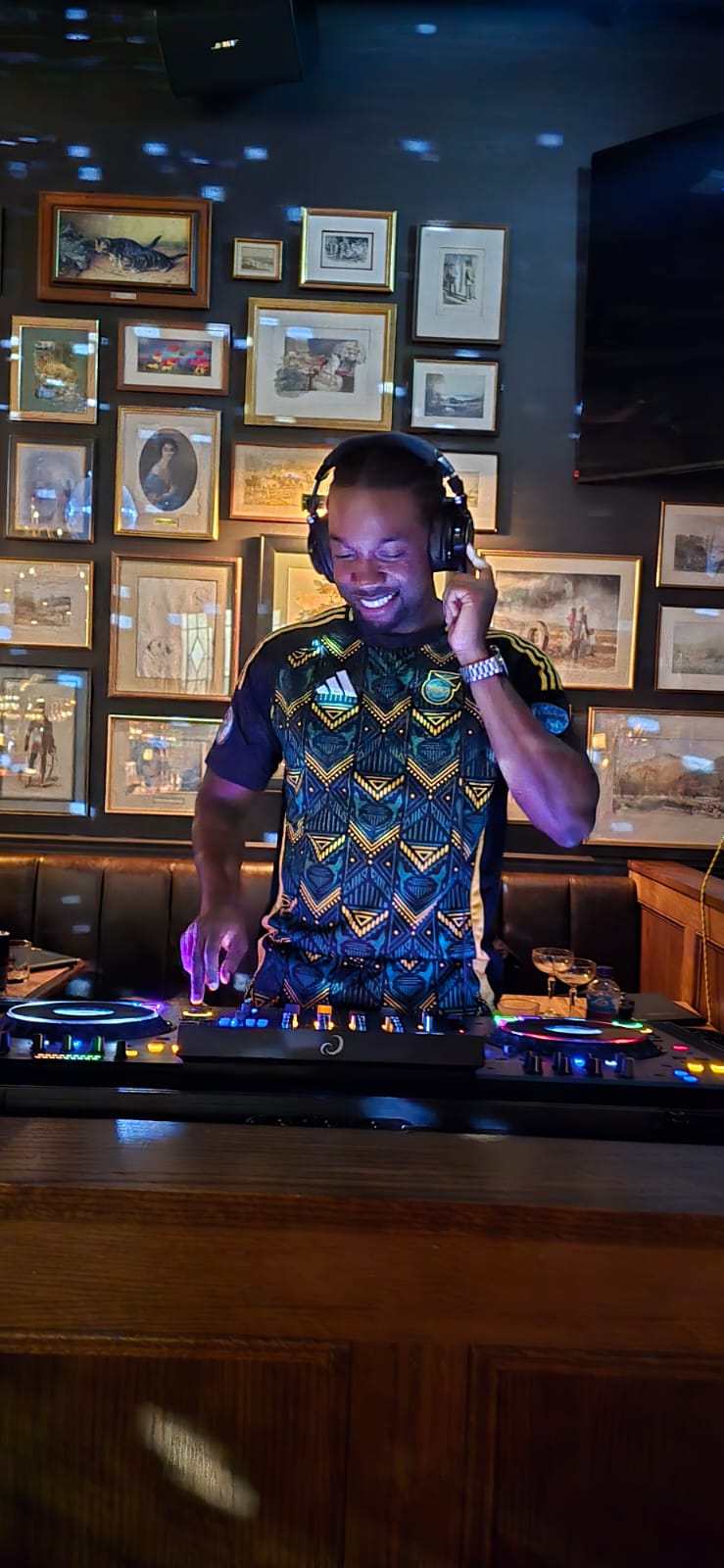 Lumos DJing behind the decks at a venue.