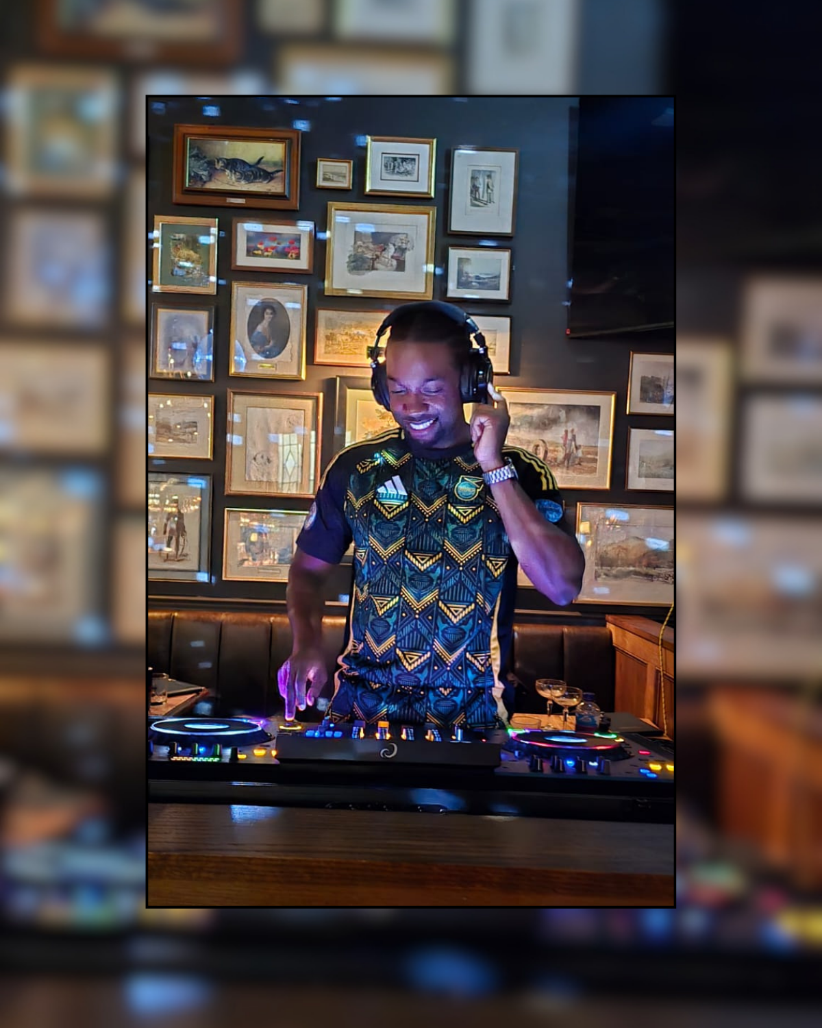 Lumos DJing behind the decks in a venue.